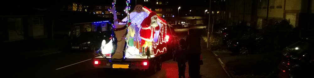 Santa on his mobile sleigh distributing sweets and good cheer in Folkestone